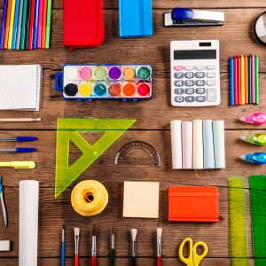 Desk with stationary. Studio shot on wooden background.