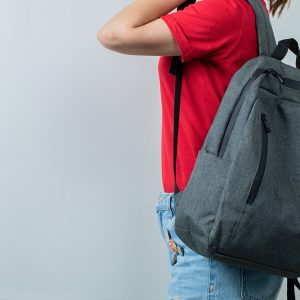 Schoolkid holding her backpack in the shoulders. High quality photo
